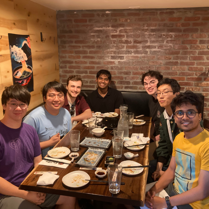A group poses around a table