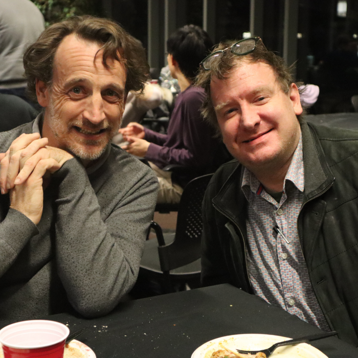 Two men pose for the camera