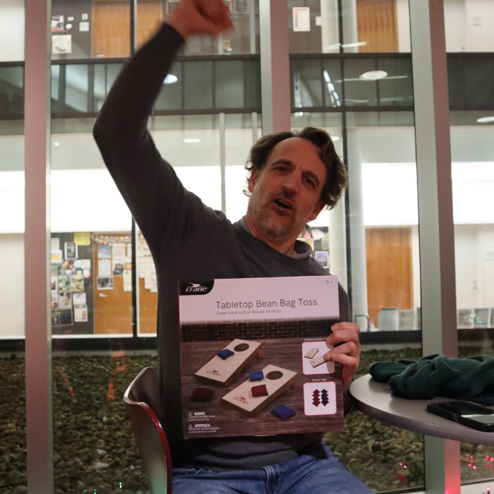 A man celebrates winning a table top game 