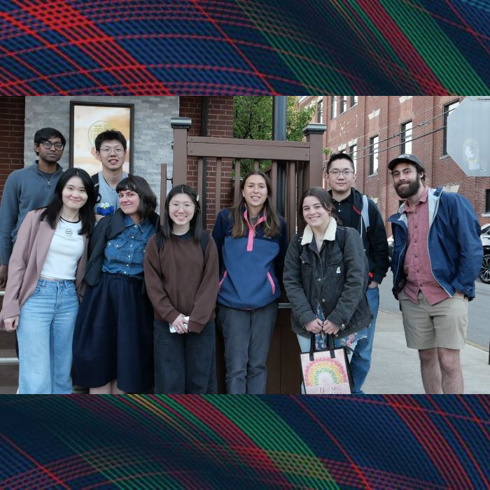 A group stands together in front of a restaurant