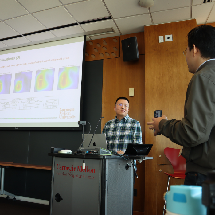 A man standing behind a podium presenting data 